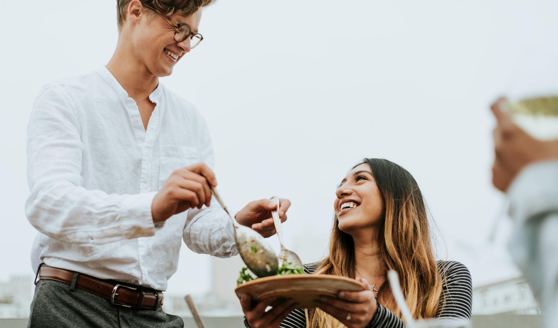 a man and a woman eating food